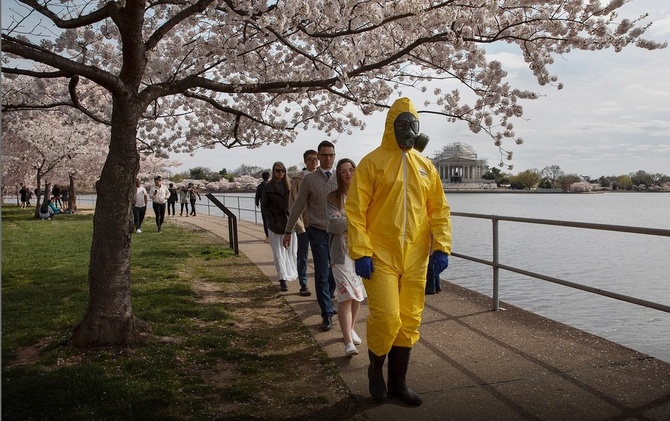 17-летний американец прогуливается со своей семьей по аллее с вишневыми деревьями в Вашингтоне. Он собирается надевать защитный костюм каждый раз, когда будет выходить из дома. Вашингтон, 22 марта ©AP Photo/Jacquelyn Martin